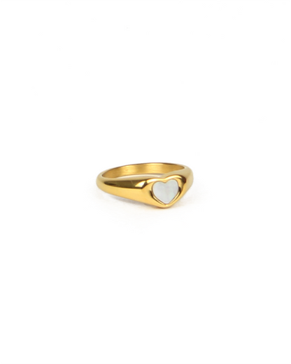 Gold ring with a heart-shaped center on a white background