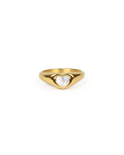 Gold ring with a heart-shaped pearl on a white background