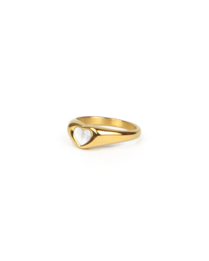 Gold ring with a heart design on a white background