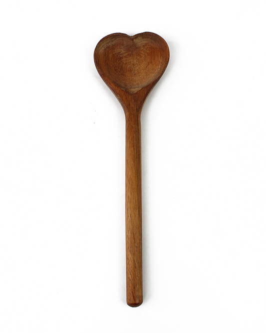 Wooden spoon with heart-shaped scoop on a white background