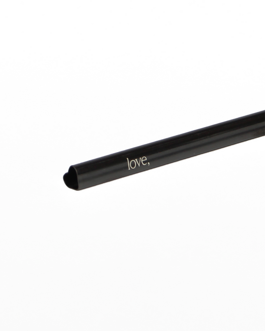 Black straw with 'love,' text on a white background