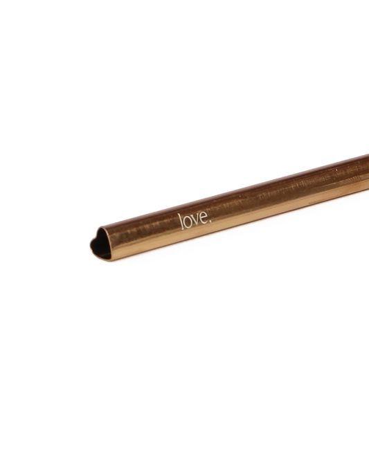Bronze-colored straw with 'love,' engraving on a white background