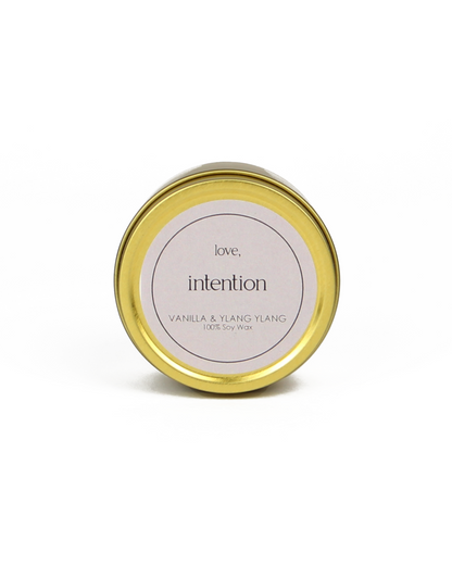 Gold candle jar with a white label on a white background
