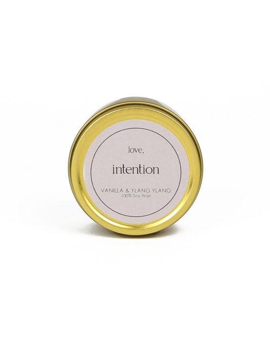 Gold candle jar with a white label on a white background