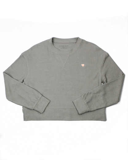 Gray sweatshirt with a small heart logo on a white background