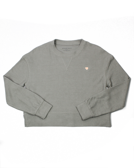 Gray sweatshirt with a small heart logo on a white background