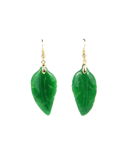 Green leaf-shaped earrings on a white background