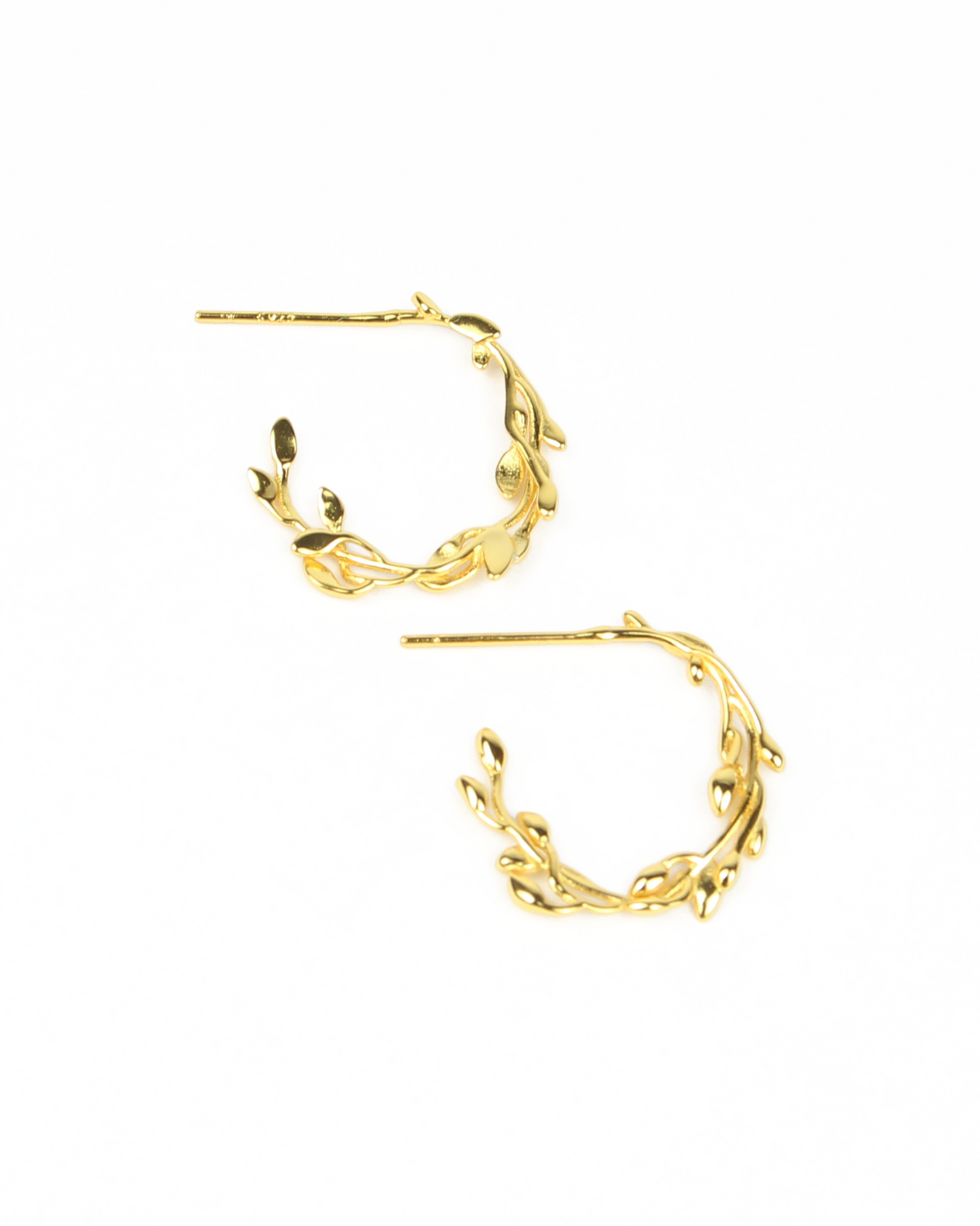 Gold hoop earrings with leaf-like designs on a white background
