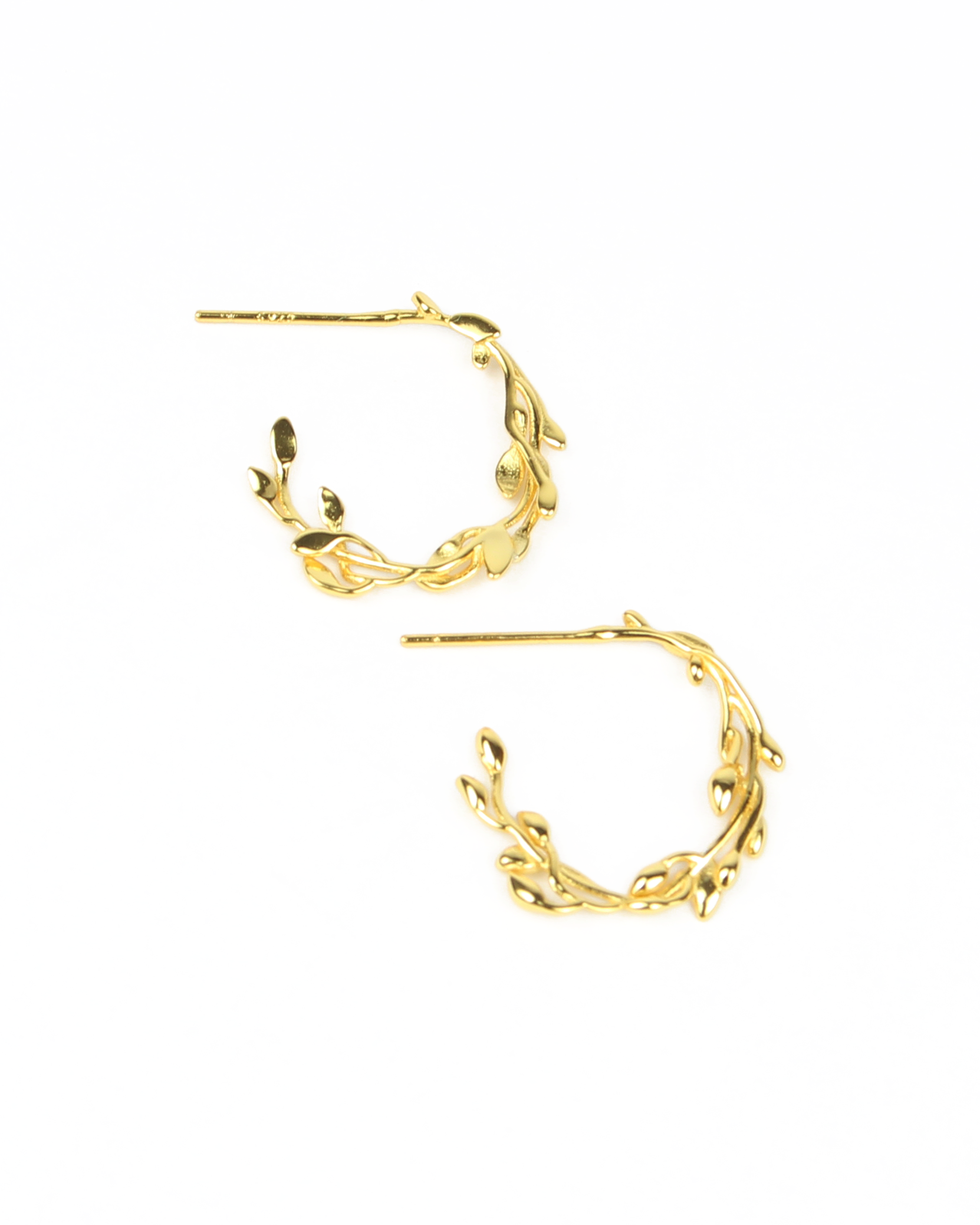 Gold hoop earrings with leaf-like designs on a white background
