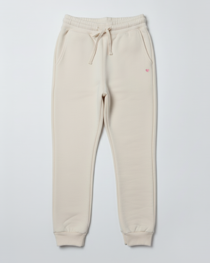 Beige sweatpants with a small red logo on a light gray background