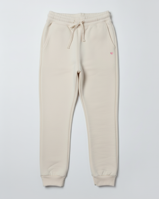 Beige sweatpants with a small red logo on a light gray background
