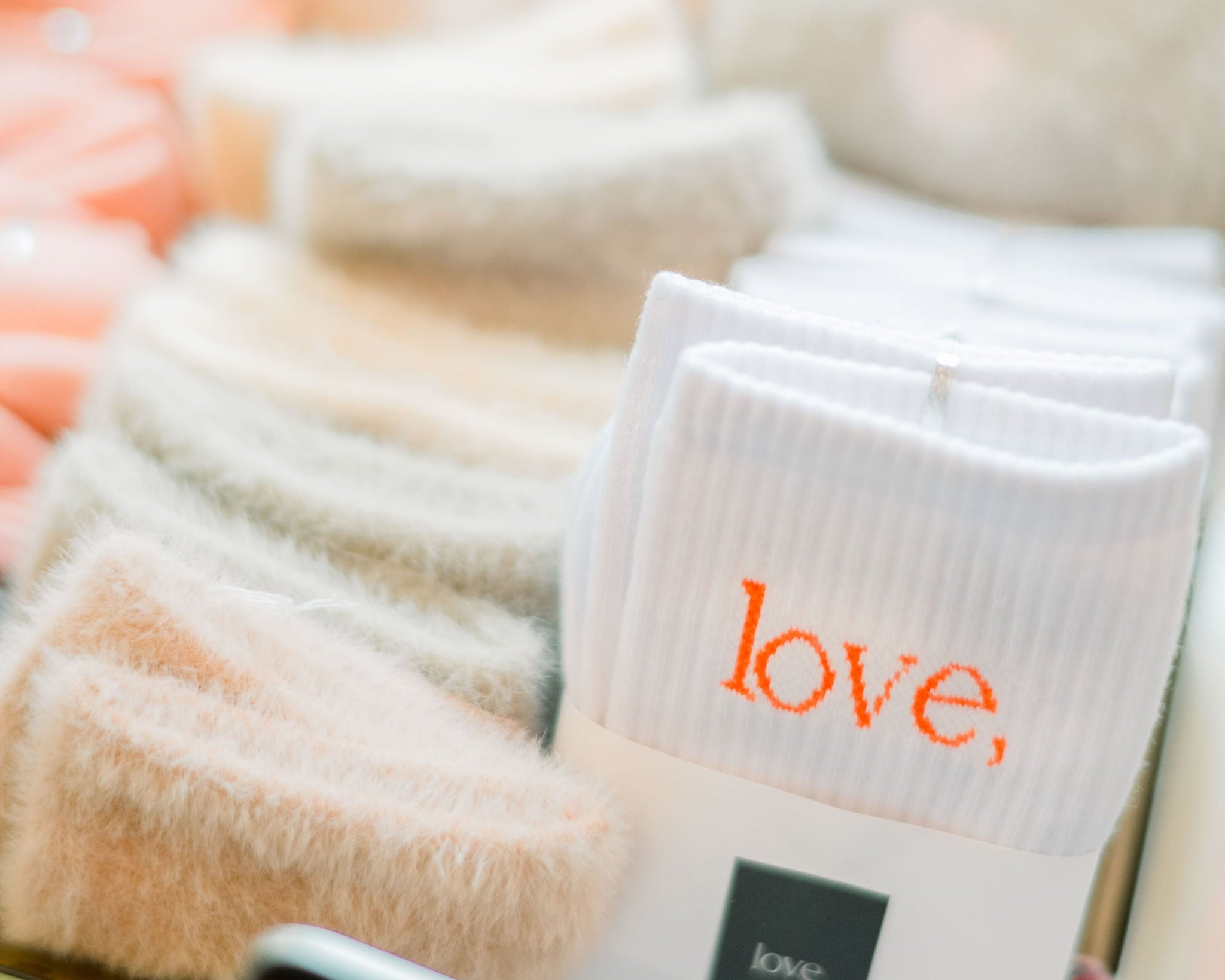 White socks with 'love' text on a blurred background