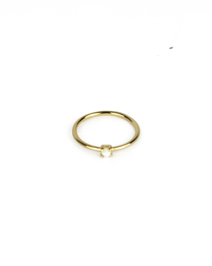 gold ring with opal gemstone on a white background