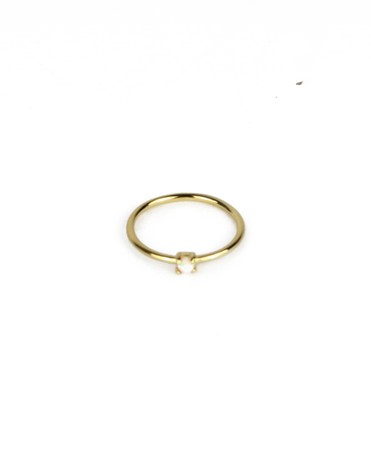 gold ring with opal gemstone on a white background