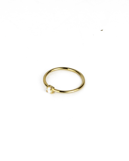 gold ring with opal gemstone on a white background