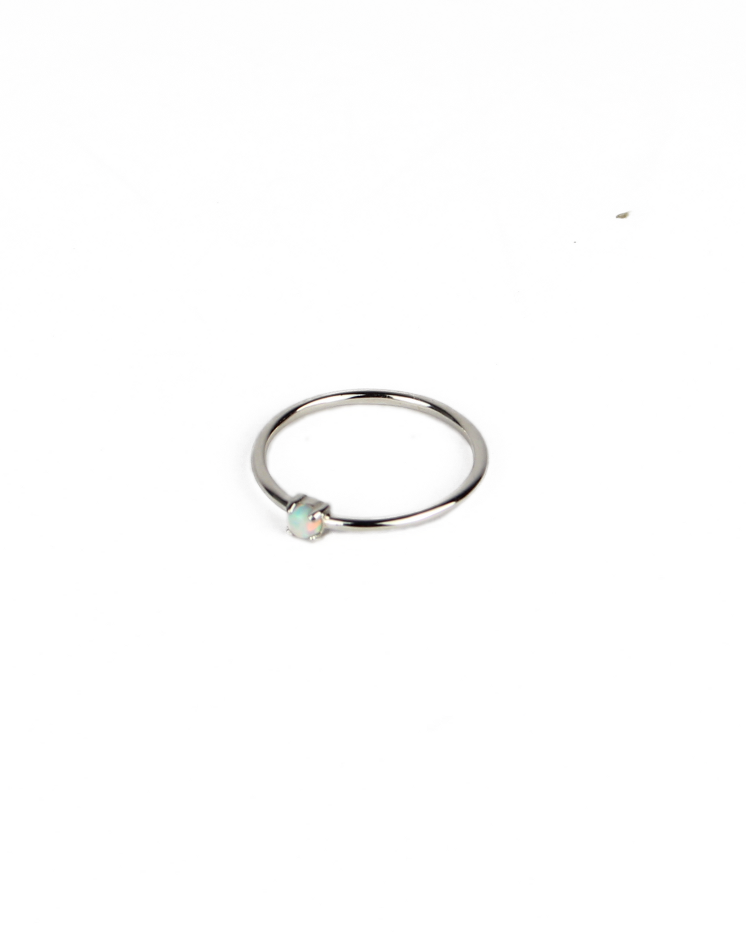 Silver ring with a small gemstone on a white background