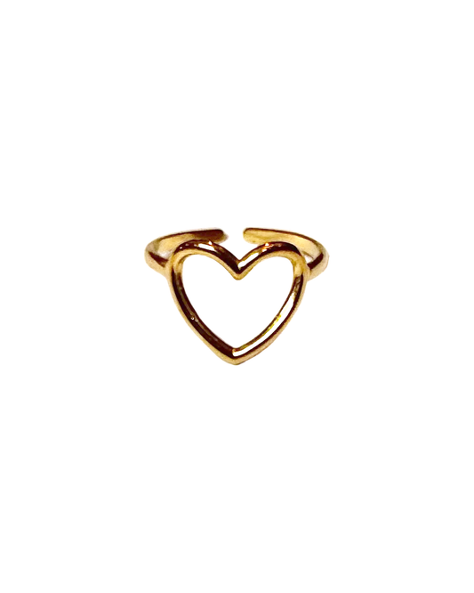 A gold heart-shaped ring with an open cutout design, resting on a white surface.