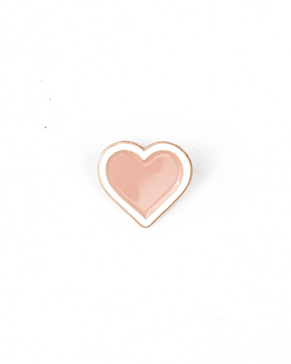 Heart-shaped pin with a pink center and gold outline on a white background
