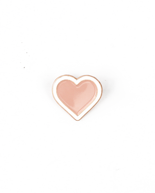 Heart-shaped pin with a pink center and gold outline on a white background
