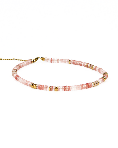 Beaded necklace with pink and gold accents on a white background