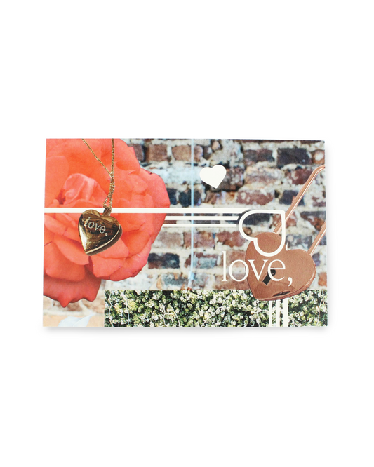Card with floral design, heart-shaped pendant, and 'love,' text on a white background
