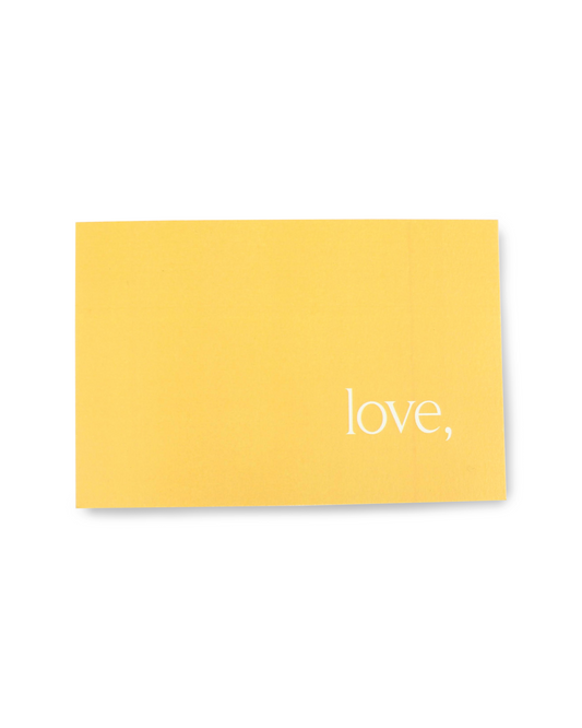 Yellow card with 'love,' text on a white background
