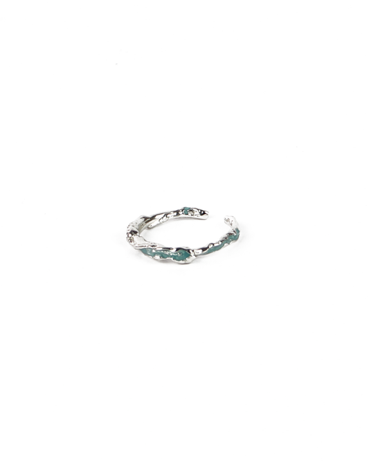 Silver ring with green-blue enamel on a white background