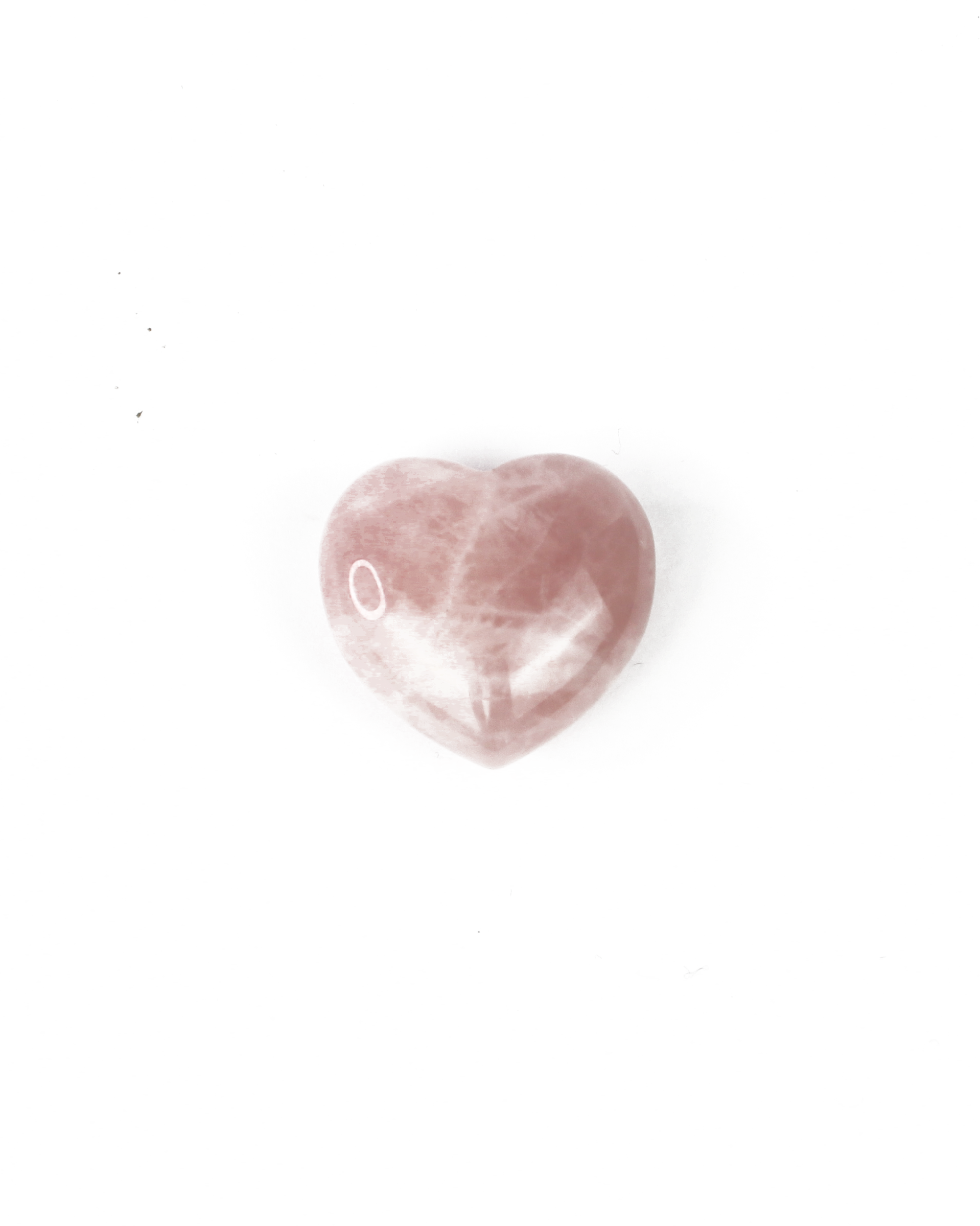 Heart-shaped pink stone on a white background