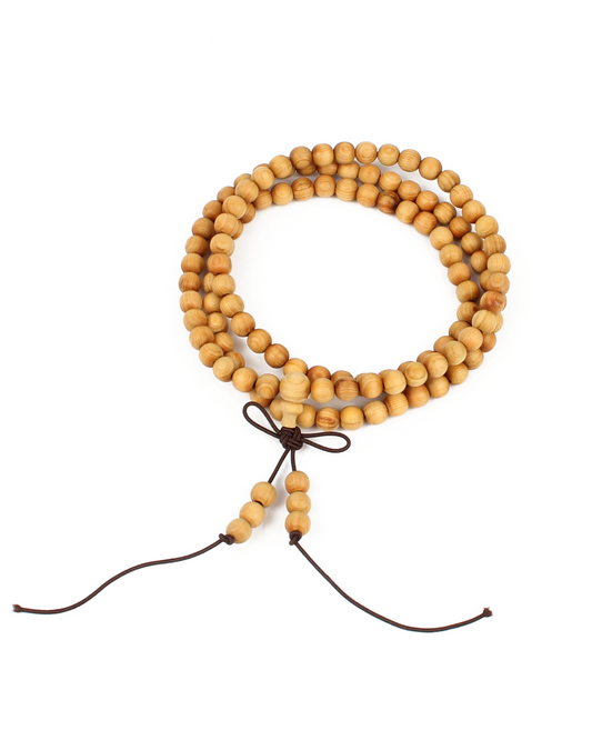 Wooden beaded necklace with a brown cord on a white background