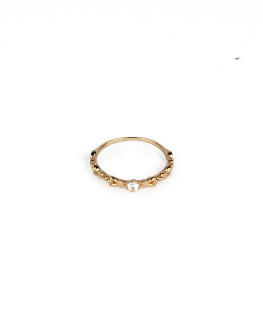 gold ring with gem stone on a white background