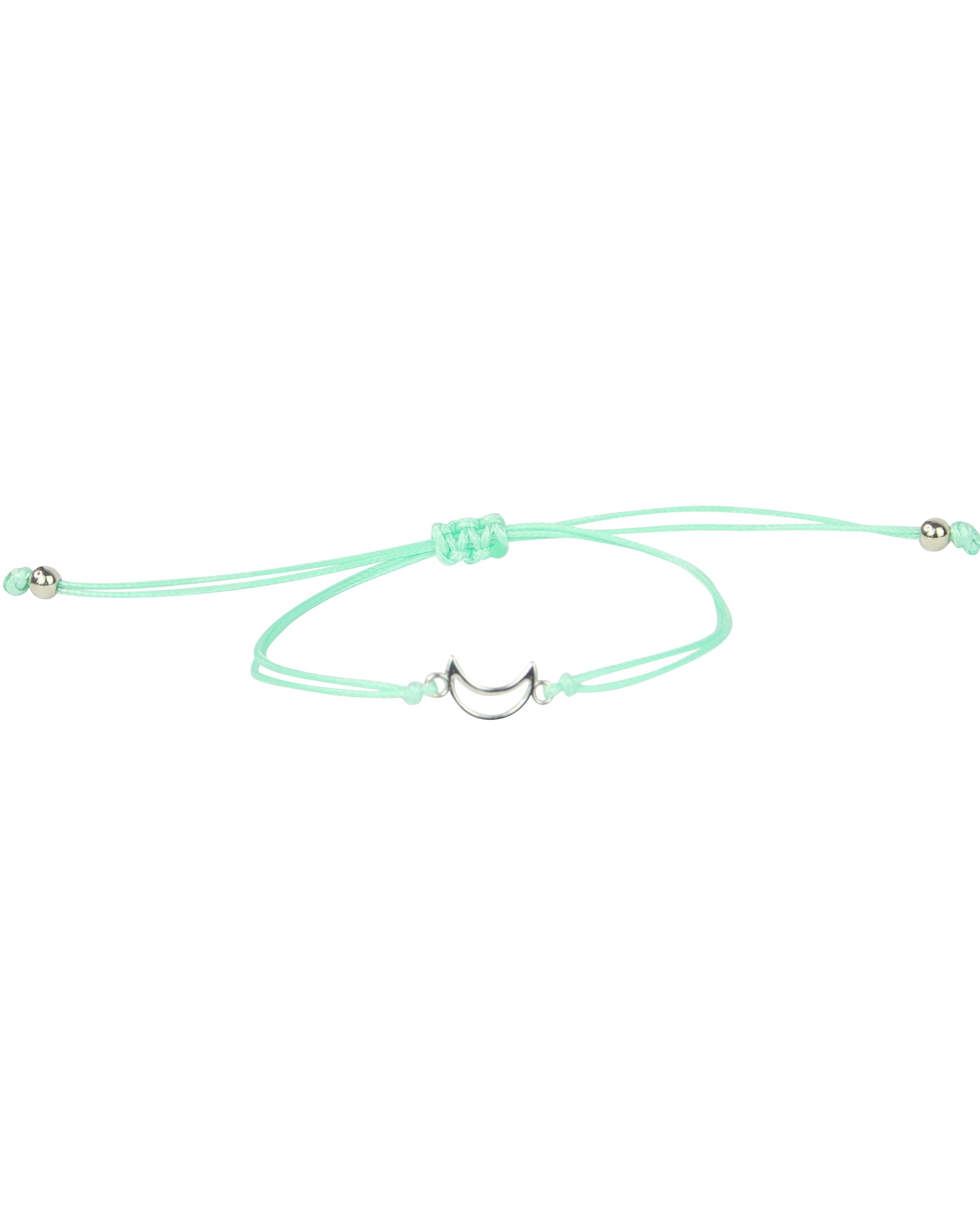 Mint green bracelet with a small charm on a white background